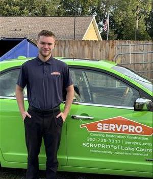 John standing in front of SERVPRO Vehicle 