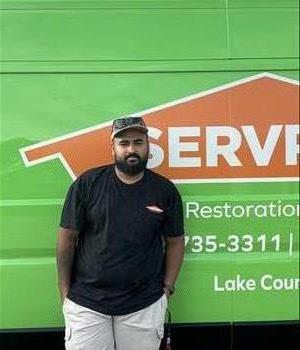 SERVPRO employee standing in front of truck