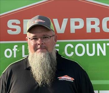 SERVPRO employee standing in front of truck